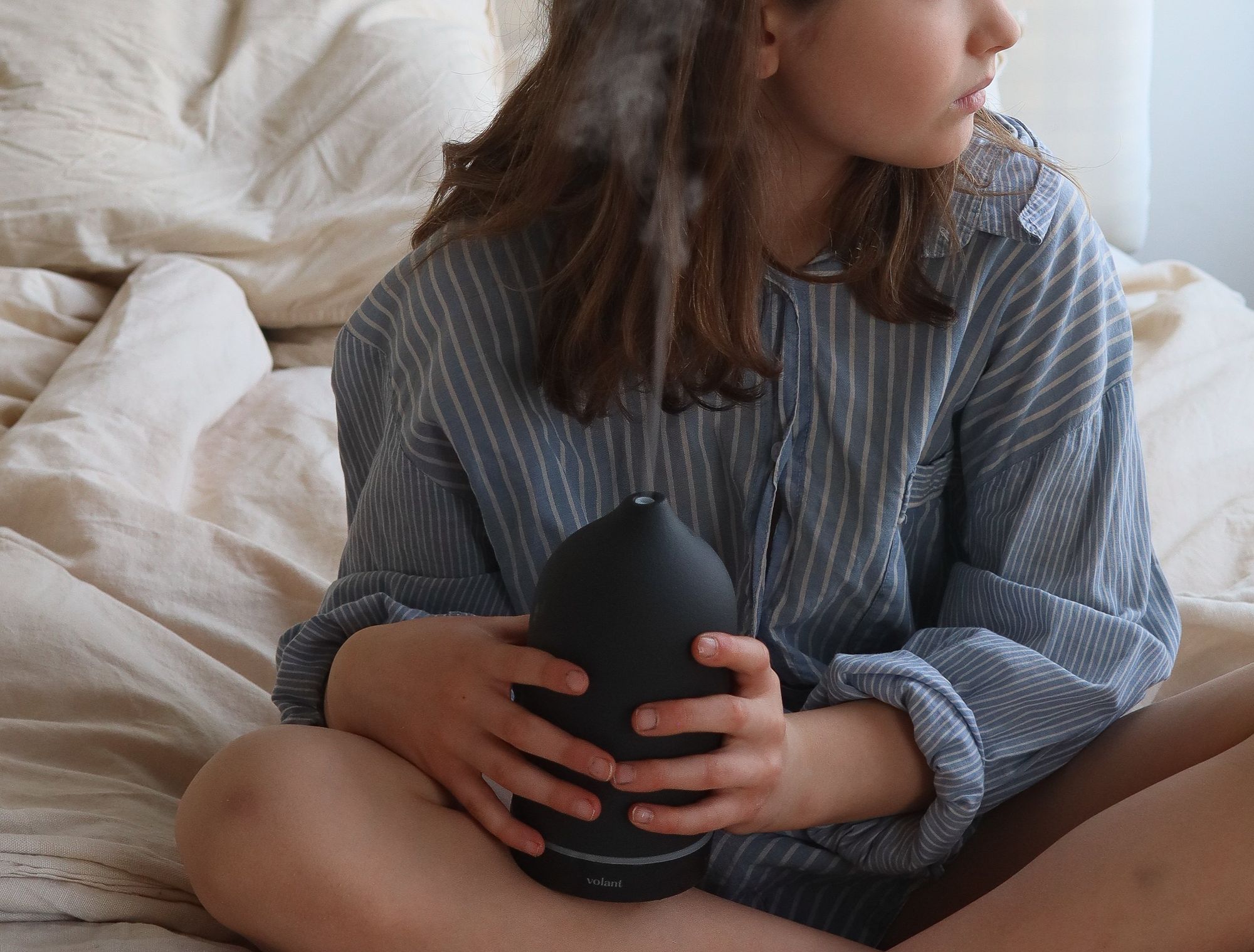 Fotografi av en jente som holder en aromadiffuser